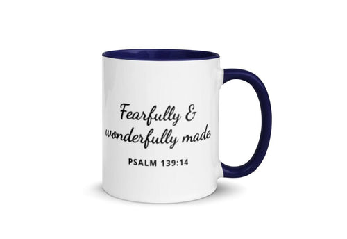 White ceramic mug with navy handle and interior, black script text "Fearfully & wonderfully made," Psalm 139:14