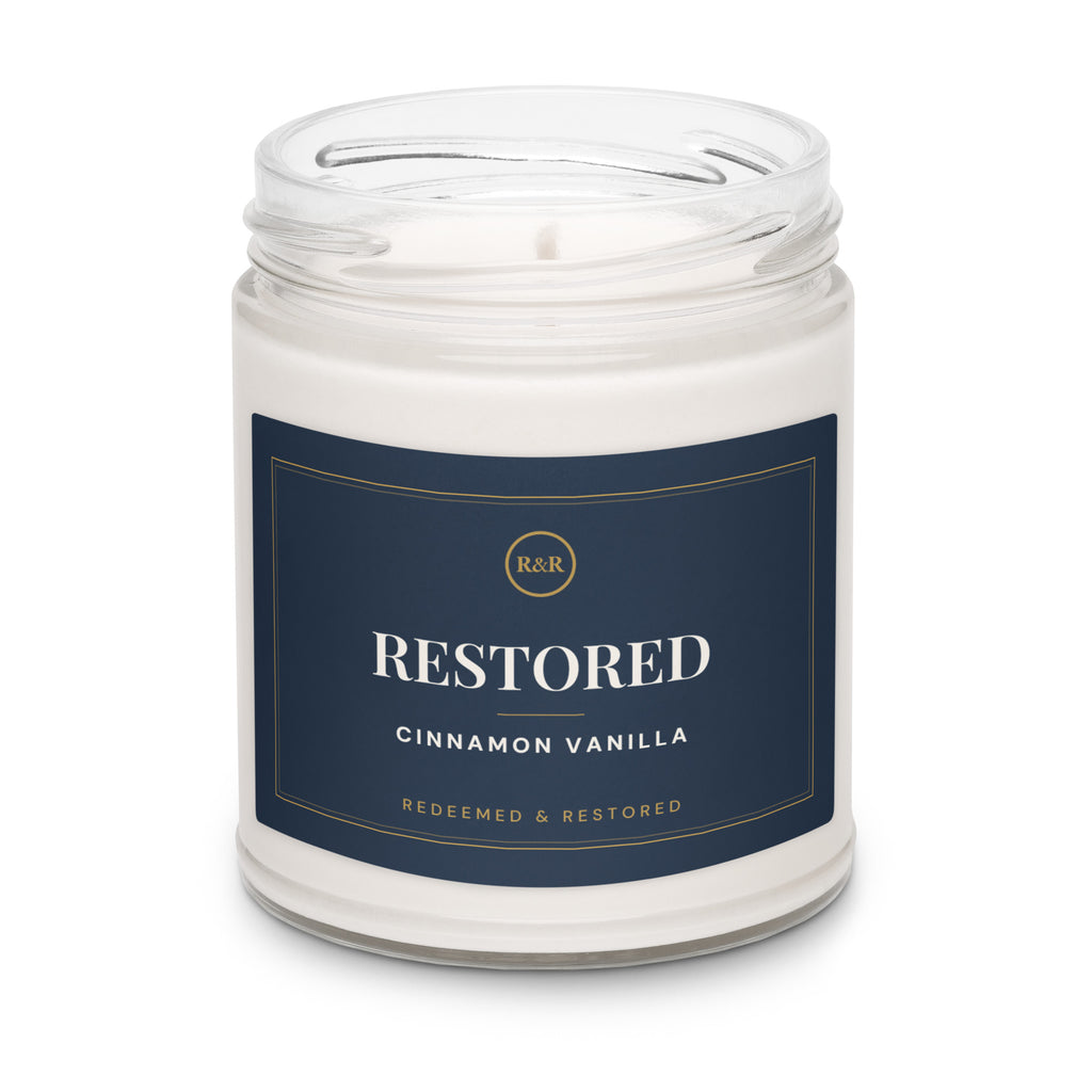 Restored Cinnamon Vanilla soy candle with the lid removed, showing white wax and wick in a clear glass jar