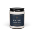 Restored Cinnamon Vanilla candle in a glass jar with black lid and navy and gold label, front view
