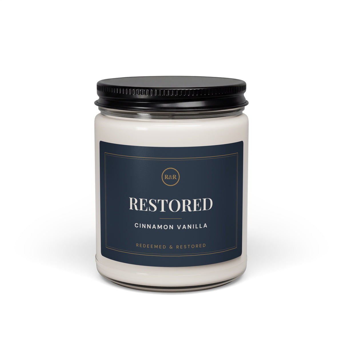 Restored Cinnamon Vanilla candle in a glass jar with black lid and navy and gold label, front view