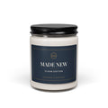 Made New Clean Cotton candle in a glass jar with black lid and navy and gold label, front view
